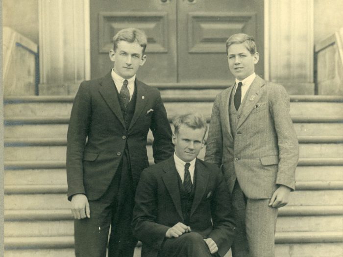 boys in suits in front of building