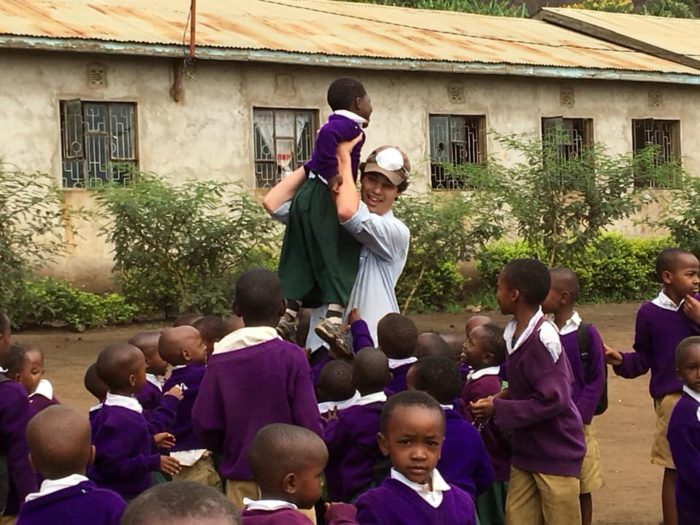 small child being picked up Tanzania Immersion