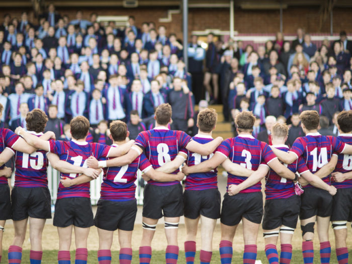 boys standing in line on rugby field