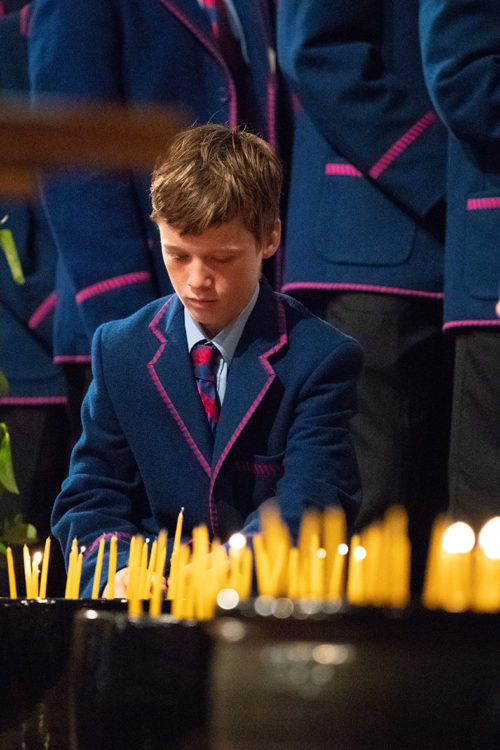 boy lighting candle
