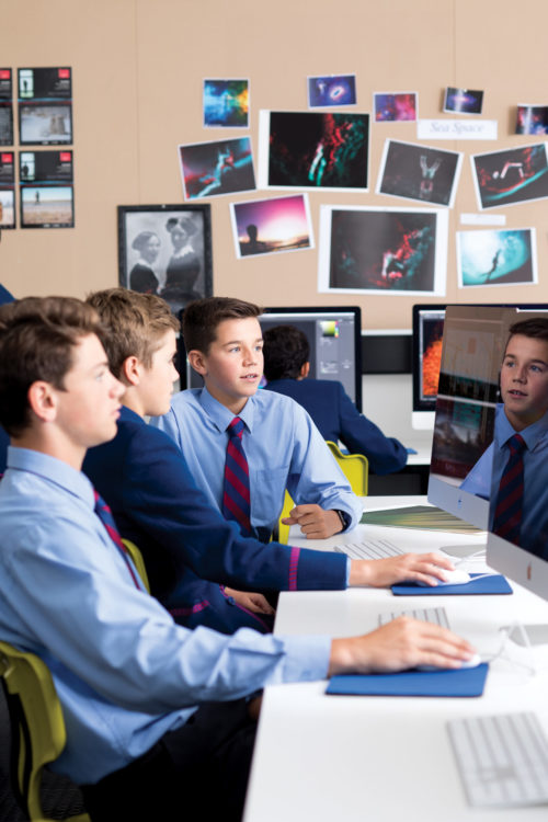 students in classroom using computers