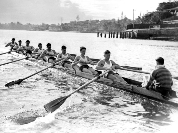 boys in rowing boat in water