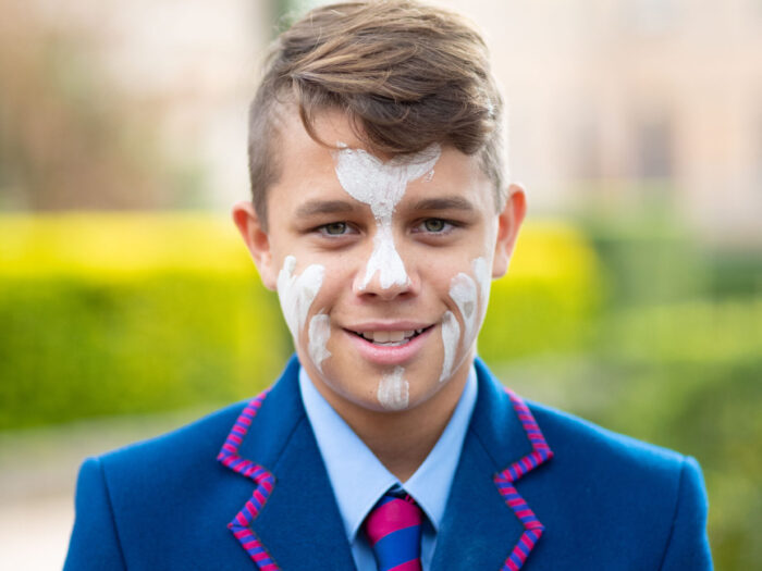 boy standing outside looking at camera with face paint