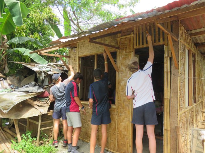 boys repairing house in the Philippines